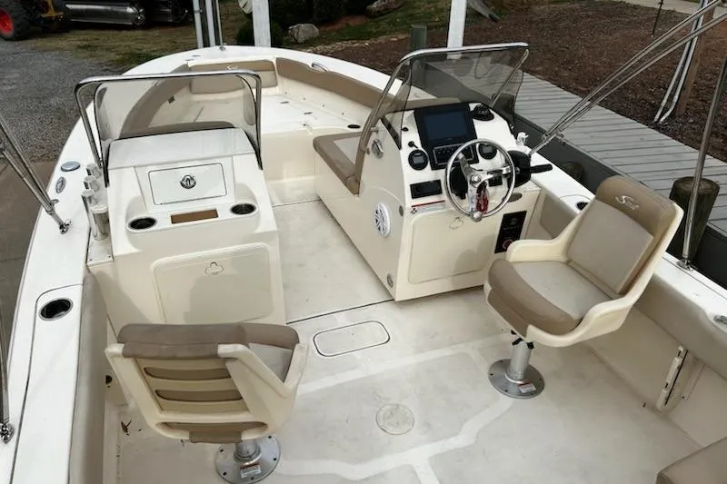 Slide: The Image of 2022 Scout 195 Sport Dorado boat interior with seating and steering console. - 8