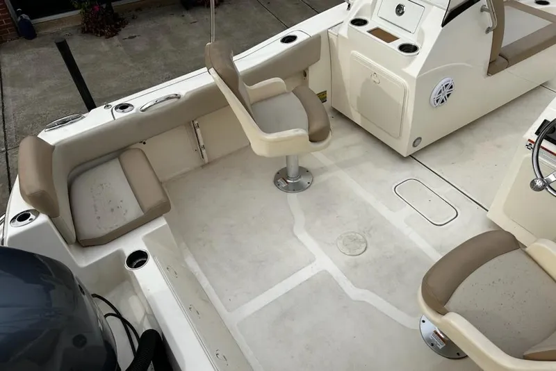 Slide: The Image of 2022 Scout 195 Sport Dorado boat interior with beige seating and console. - 9