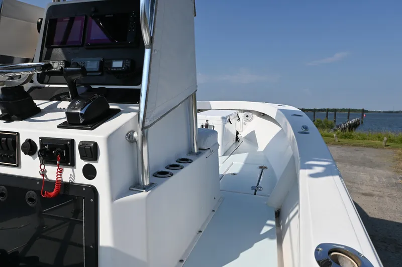 Slide: The Image of 1983 SeaVee 260B boat interior with control panel, docked by the water. - 11