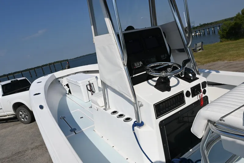 Slide: The Image of 1983 SeaVee 260B boat with modern helm, docked near a white truck. - 12