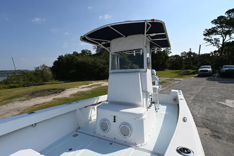 Slide: The Image of 1983 SeaVee 260B boat with T-top, parked on a sunny day near greenery. - 13