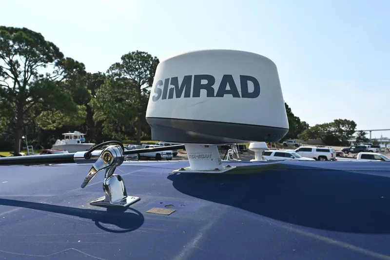 Slide: The Image of Simrad radar on 1983 SeaVee 260B boat, parked outdoors with trees and vehicles. - 14