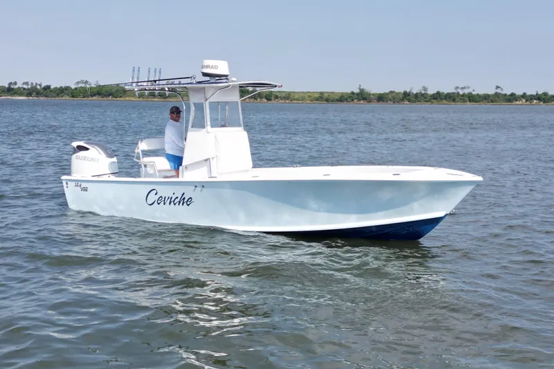 Slide: The Image of 1983 SeaVee 260B boat on water, featuring Suzuki engine and Simrad equipment. - 2