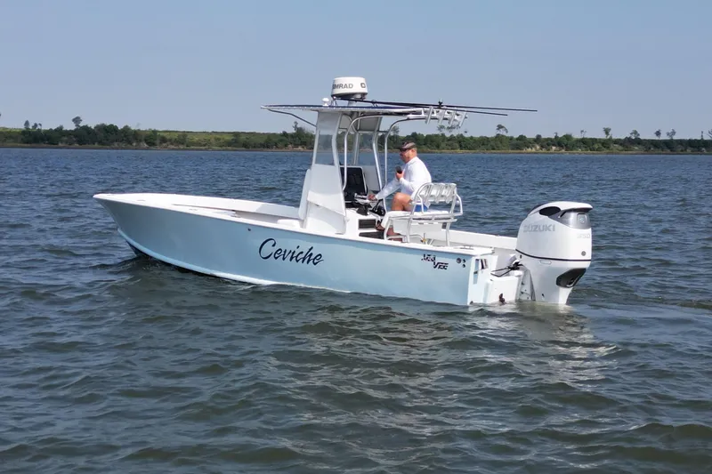 Slide: The Image of 1983 SeaVee 260B boat on water, featuring Suzuki outboard motor. - 3