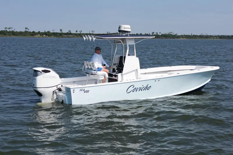 Slide: The Image of 1983 SeaVee 260B boat on water, featuring Suzuki outboard motor. - 4