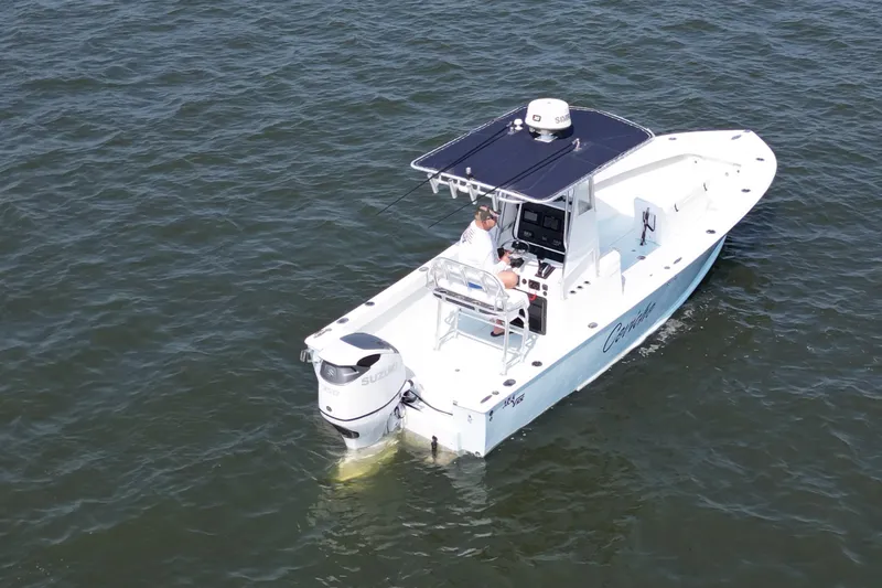 Slide: The Image of 1983 SeaVee 260B boat on water, featuring Suzuki outboard motor and canopy. - 5