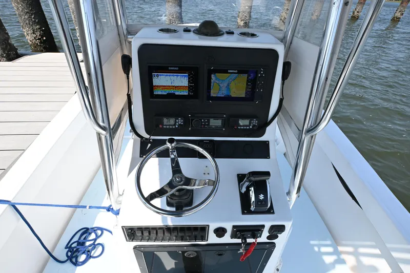 Slide: The Image of 1983 SeaVee 260B boat console with navigation equipment and steering wheel. - 7