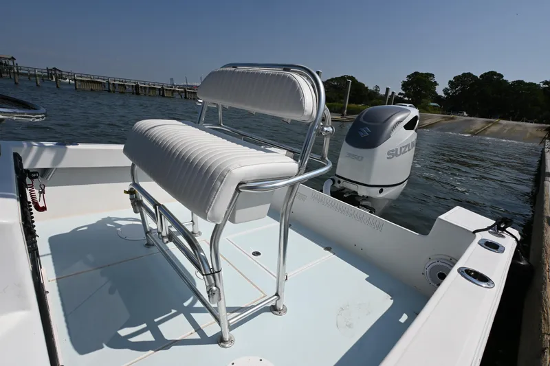 Slide: The Image of 1983 SeaVee 260B boat with Suzuki engine, featuring a white cushioned seat. - 9