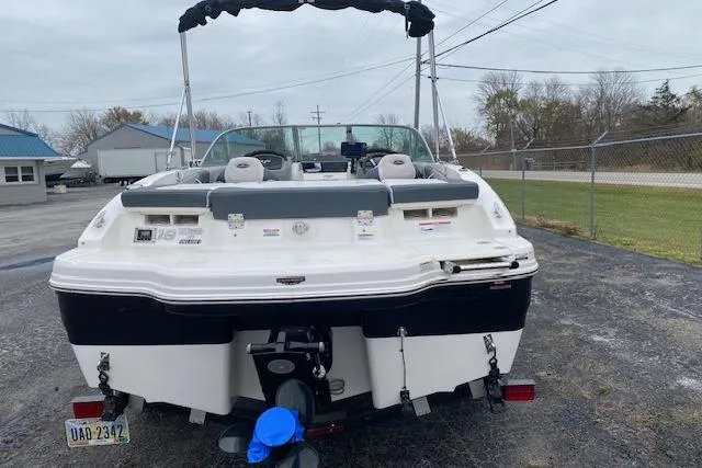Slide: The Image of 2019 Chaparral 19 H2O Sport boat, rear view, parked outdoors on a cloudy day. - 10