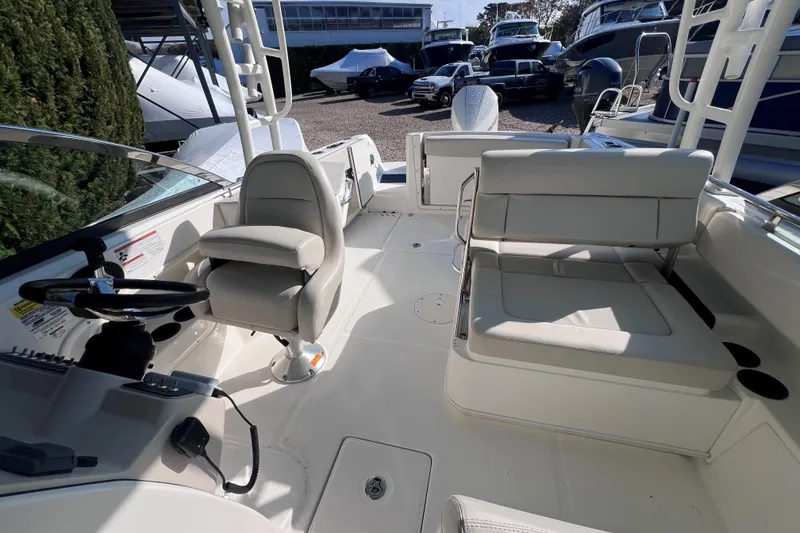 Slide: The Image of 2020 Boston Whaler 230 Vantage boat interior with seating and steering wheel. - 11