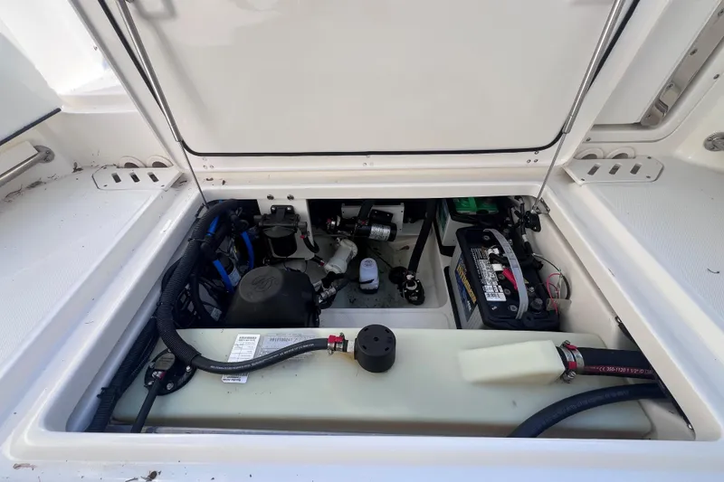 Slide: The Image of 2020 Boston Whaler 230 Vantage engine compartment with battery and wiring. - 15