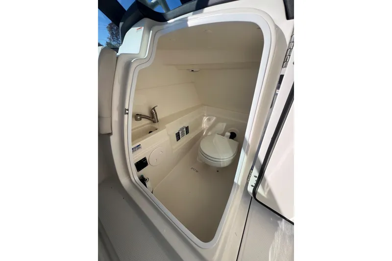 Slide: The Image of 2020 Boston Whaler 230 Vantage boat interior with compact marine toilet and sink. - 21