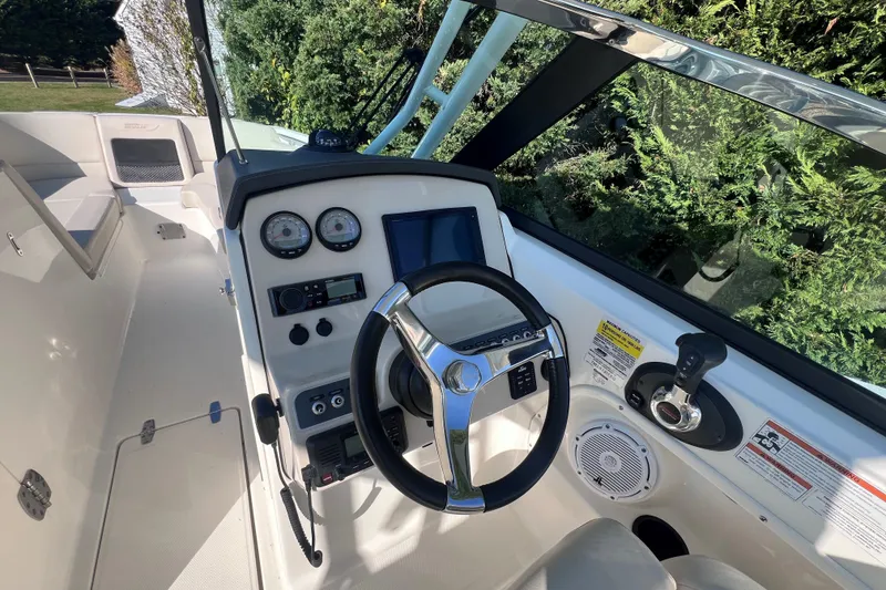 Slide: The Image of 2020 Boston Whaler 230 Vantage boat cockpit with steering wheel and control panel. - 23