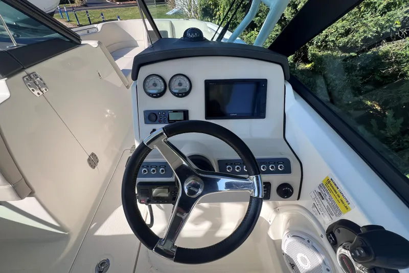 Slide: The Image of 2020 Boston Whaler 230 Vantage boat dashboard with steering wheel and controls. - 24