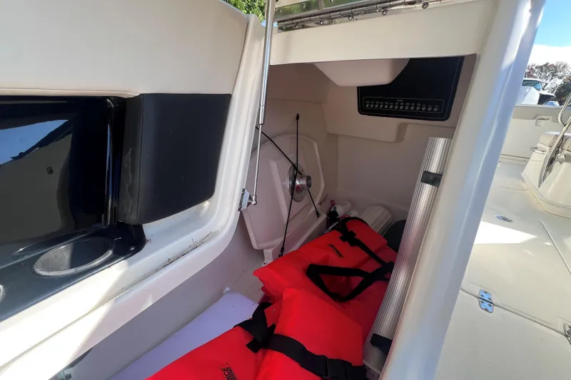 Slide: The Image of Interior storage of 2020 Boston Whaler 230 Vantage with life jackets and equipment. - 25