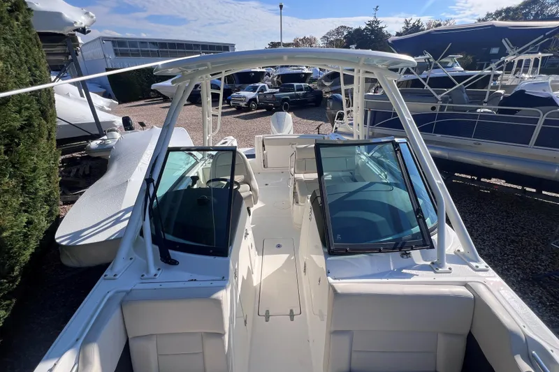 Slide: The Image of 2020 Boston Whaler 230 Vantage boat with dual consoles and open deck, docked outdoors. - 26