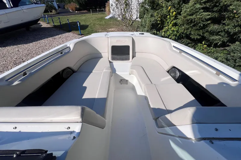 Slide: The Image of 2020 Boston Whaler 230 Vantage boat interior with cushioned seating and speakers. - 27