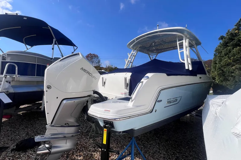Slide: The Image of 2020 Boston Whaler 230 Vantage boat with Mercury outboard engine, parked outdoors. - 5