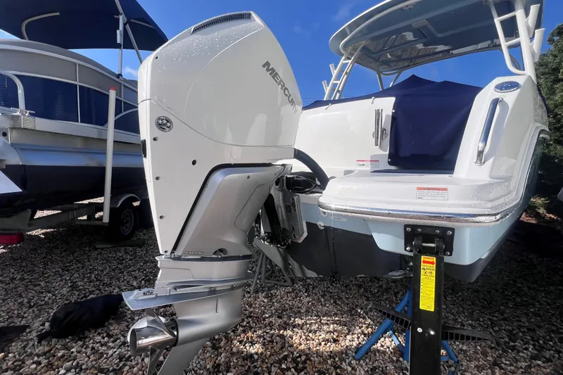Slide: The Image of 2020 Boston Whaler 230 Vantage with Mercury outboard engine, displayed on gravel. - 7