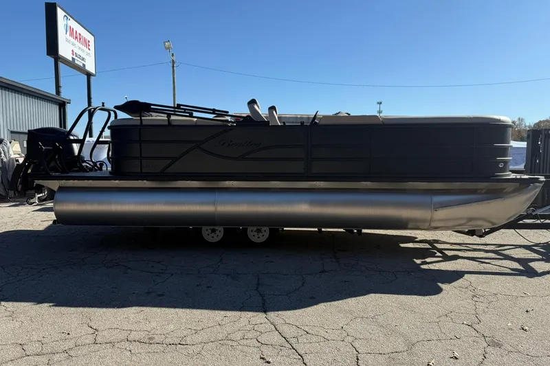 Slide: The Image of 2026 Bentley Pontoons Legacy 223 Navigator, sleek design, parked outdoors, side view. - 2