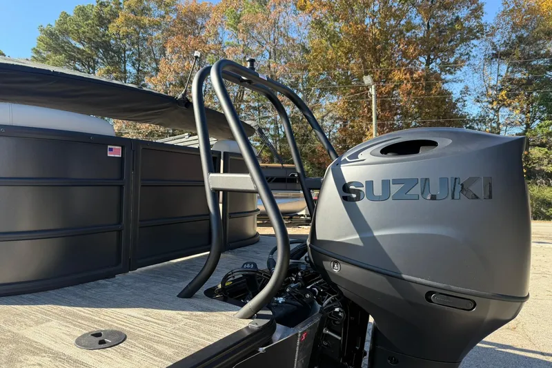 Slide: The Image of 2026 Bentley Pontoons Legacy 223 Navigator with Suzuki outboard motor, parked outdoors. - 6