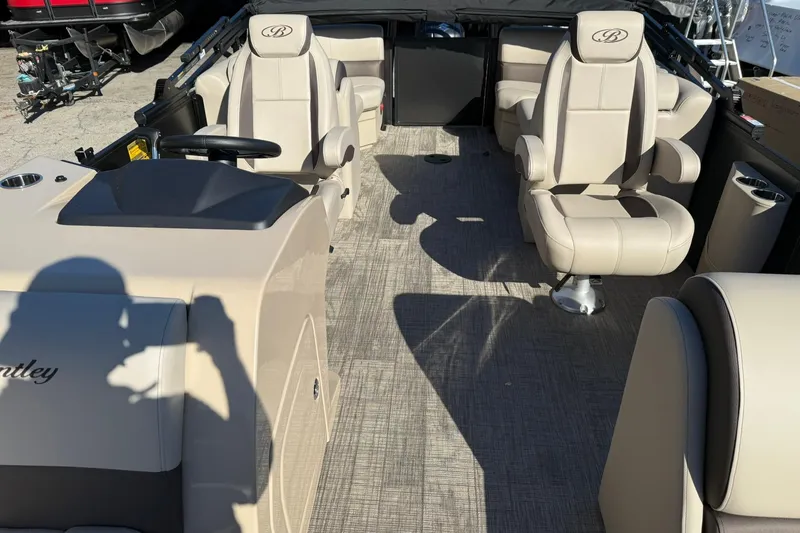 Slide: The Image of 2026 Bentley Pontoons Legacy 223 Navigator interior with beige seating and modern design. - 7