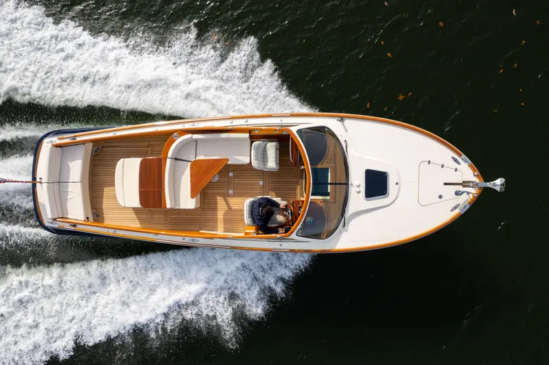 Slide: The Image of Overhead view of 2006 Hinckley Talaria 29 R boat cruising on water. - 10