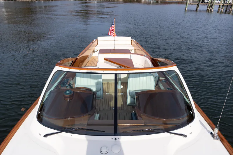 Slide: The Image of 2006 Hinckley Talaria 29 R yacht with elegant wood detailing on calm water. - 12