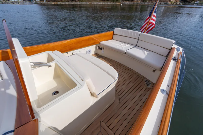 Slide: The Image of 2006 Hinckley Talaria 29 R boat with teak deck and cushioned seating. - 18