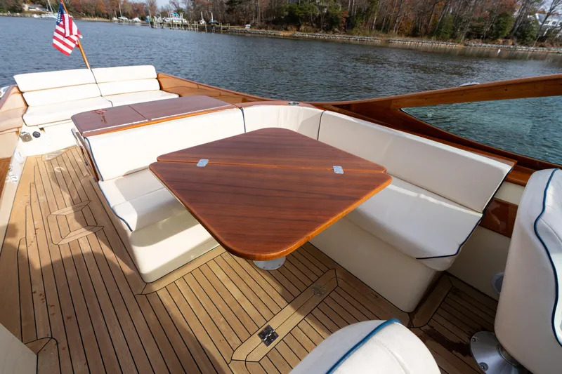 Slide: The Image of Hinckley Talaria 29 R 2006 boat interior with wooden table and cushioned seating. - 22
