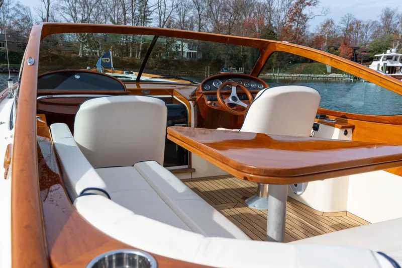Slide: The Image of Luxurious 2006 Hinckley Talaria 29 R boat interior with wooden accents and white seating. - 23