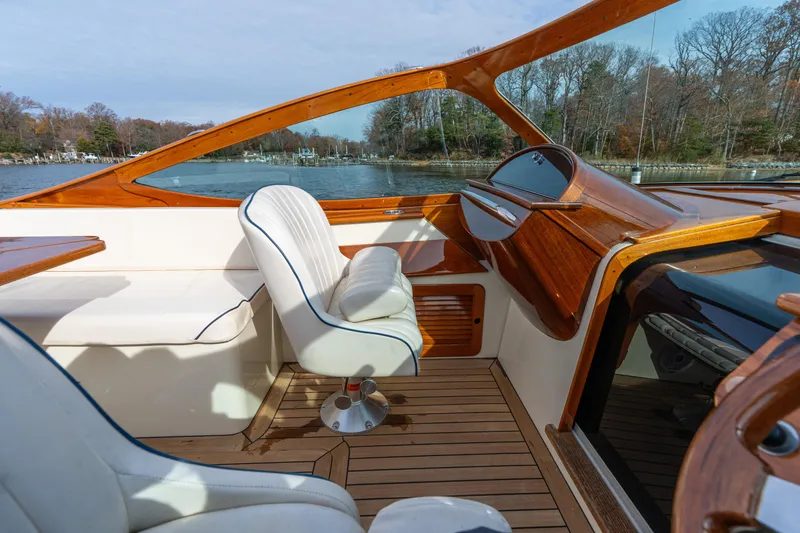 Slide: The Image of 2006 Hinckley Talaria 29 R interior with elegant wood finish and white seating. - 25