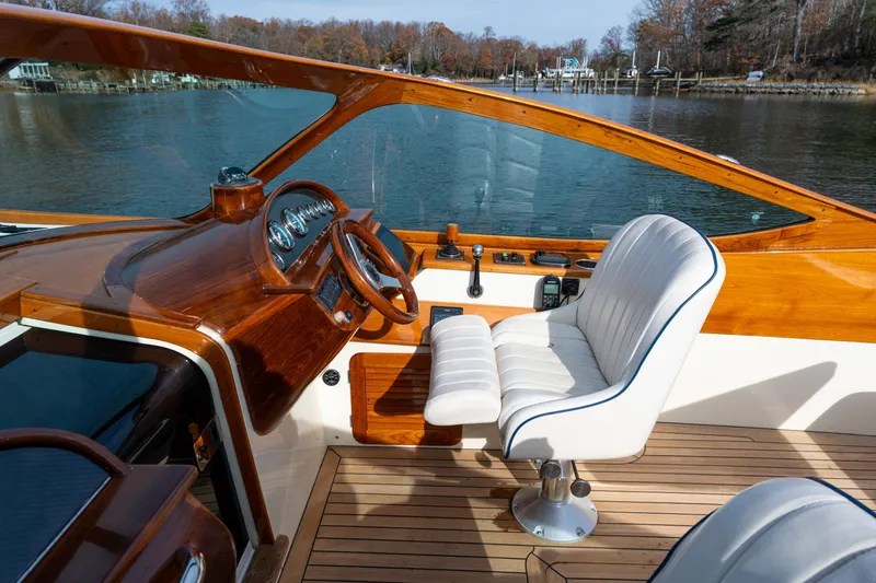 Slide: The Image of 2006 Hinckley Talaria 29 R cockpit with wooden dashboard and white leather seating. - 30