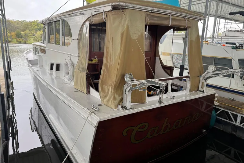 Slide: The Image of Custom 1987 Cedar Craft boat named "Cabana" docked at a marina. - 10