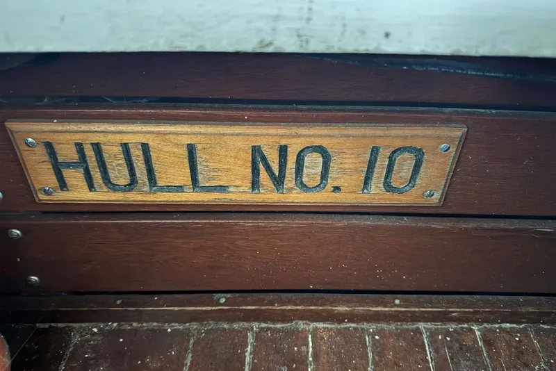 Slide: The Image of Wooden plaque reading "Hull No. 10" on a 1987 Custom Cedar Craft boat. - 11