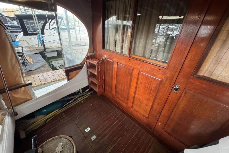 Slide: The Image of Wooden interior of 1987 Custom Cedar Craft boat with dock view. - 12
