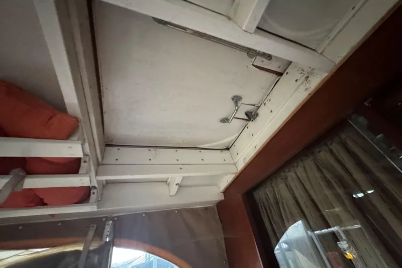 Slide: The Image of Interior view of a 1987 Custom Cedar Craft boat with wooden and metal details. - 14