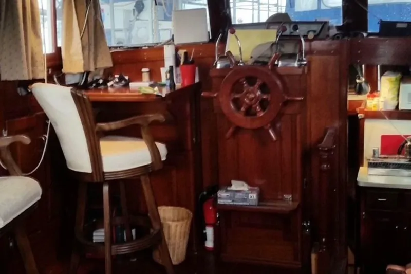 Slide: The Image of Interior of a 1987 Custom Cedar Craft boat with wooden helm and seating. - 18