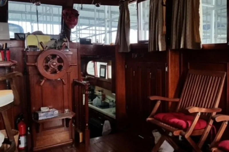 Slide: The Image of Interior of 1987 Custom Cedar Craft boat with wooden helm and seating. - 19