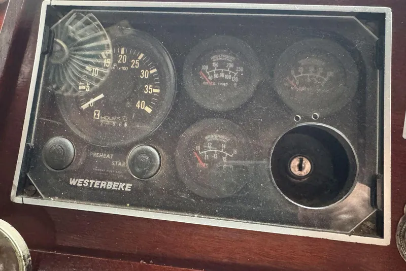 Slide: The Image of Vintage 1987 Cedar Craft dashboard with Westerbeke gauges and ignition key slot. - 21