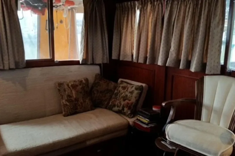 Slide: The Image of Cozy 1987 Custom Cedar Craft interior with vintage seating and floral cushions. - 22