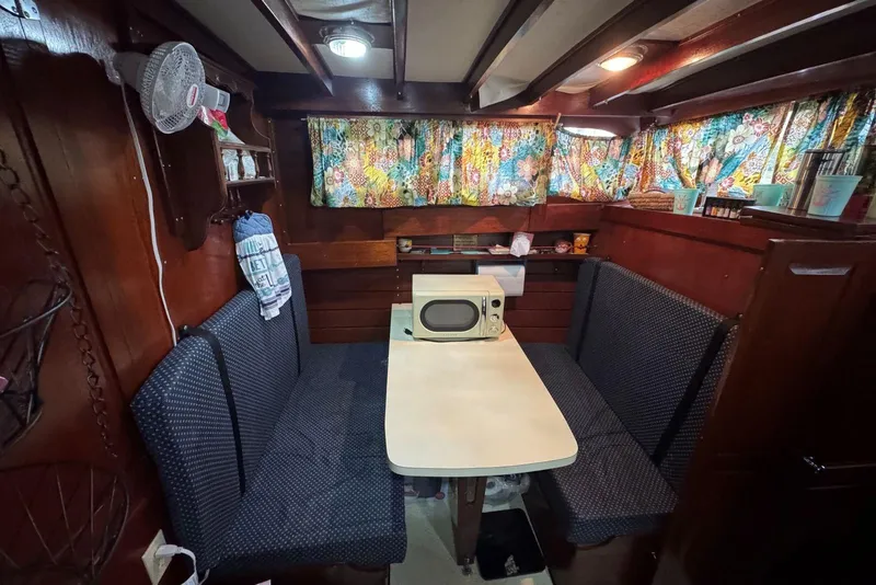 Slide: The Image of Cozy 1987 Custom Cedar Craft boat interior with dining area and vintage decor. - 25