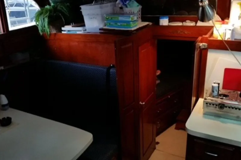 Slide: The Image of Interior of a 1987 Custom Cedar Craft boat with wooden cabinetry and seating area. - 27