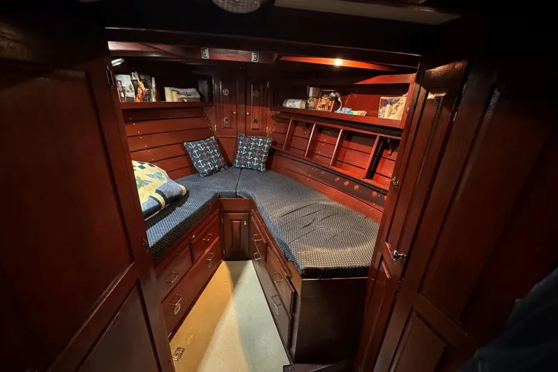Slide: The Image of Cozy wooden cabin interior of 1987 Custom Cedar Craft boat with cushioned seating. - 28