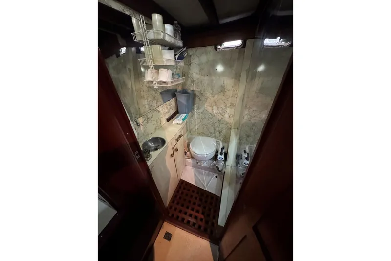 Slide: The Image of Compact 1987 Custom Cedar Craft bathroom with sink, toilet, and storage shelves. - 32