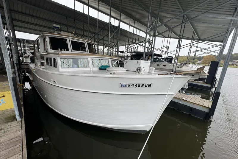 Slide: The Image of 1987 Custom Cedar Craft boat docked under a metal canopy. - 7