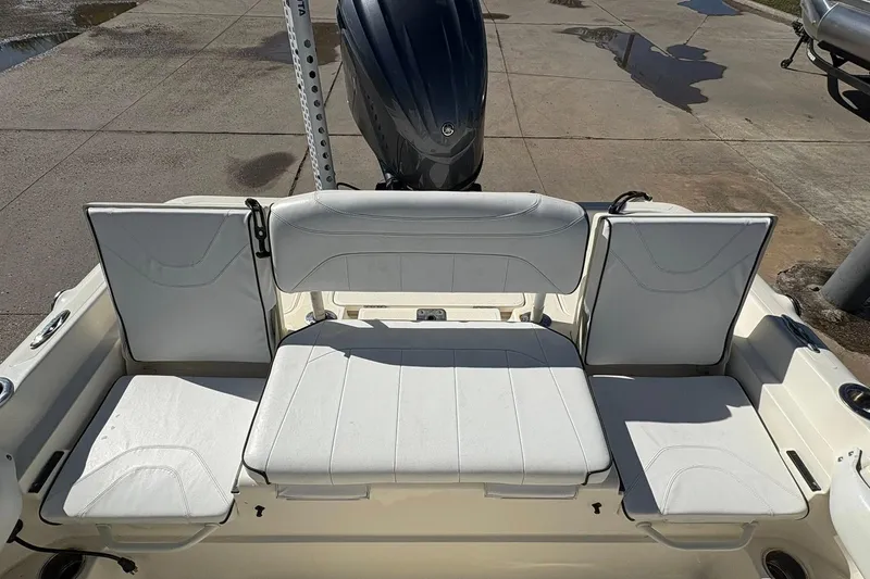 Slide: The Image of 2023 Skeeter SX2550 Family boat with white cushioned seating and motor. - 19