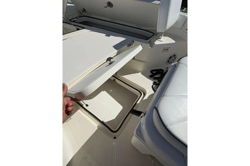 Slide: The Image of 2023 Skeeter SX2550 Family boat interior storage compartment with cushioned seating. - 23