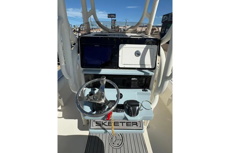 Slide: The Image of 2023 Skeeter SX2550 Family boat dashboard with steering wheel and controls. - 4