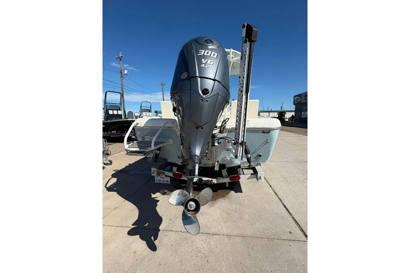 Slide: The Image of 2023 Skeeter SX2550 Family boat with powerful 300 V6 engine, parked outdoors. - 5